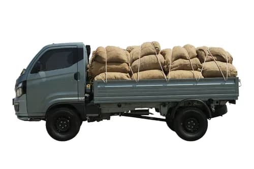 Tata Intra V50 Gold left side profile view - loaded jute sacks cargo mini truck India 2026