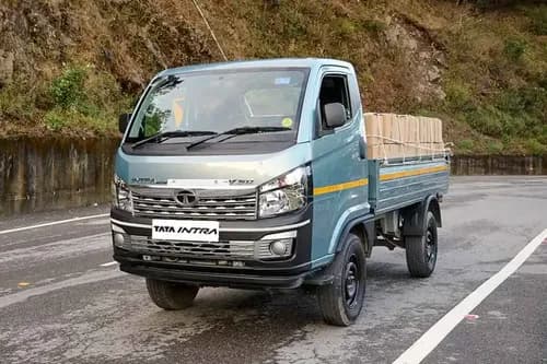 Tata Intra V50 LNT front left three-quarter view - loaded cargo mountain road mini truck India 2026