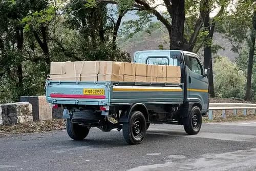 Tata Intra V50 LNT rear right three-quarter view - loaded flatbed cargo body mini truck India 2026