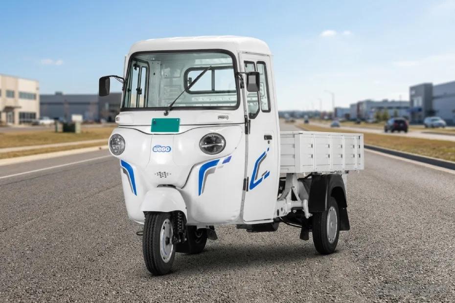Bajaj WEGO C90 electric three-wheeler front view with white cargo loading bed on road Bajaj WEGO C90 electric three-wheeler front view with white cargo loading bed on road