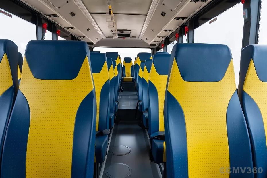 EKA 9M School Bus interior with comfortable blue and yellow passenger seats and spacious aisle EKA 9M School Bus interior with comfortable blue and yellow passenger seats and spacious aisle